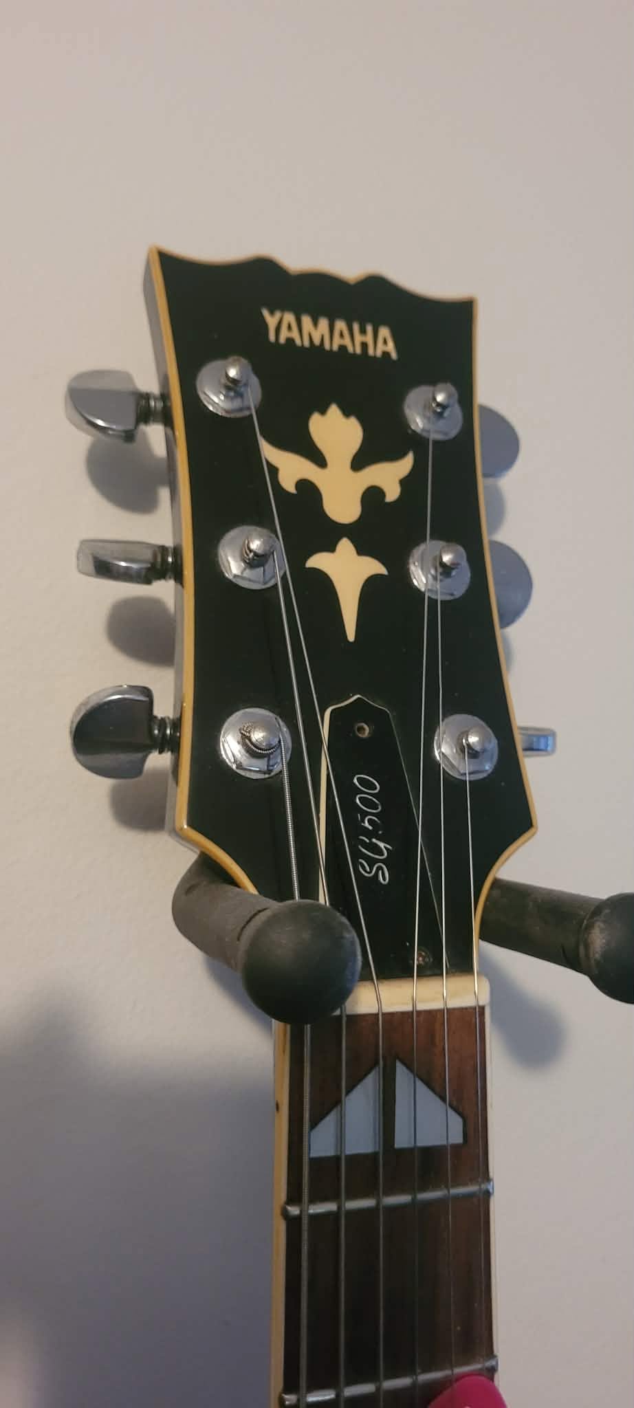 What is the age of a Yamaha SG500 guitar with serial number 1297?
