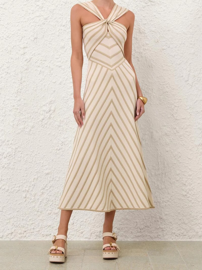 Shimmer after dark. ✨ The Luna Metallic Halter Dress by Zimmermann is the statement piece your season has been waiting for. Cut in a luminous metallic fabrication with a flattering halter neckline