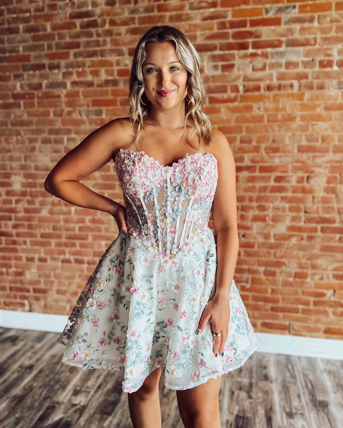 stunning homecoming dress Stop scrolling… your dream just arrived. 💐✨ This one-of-a-kind dress features: 🌸 3D floral appliqués 🌸 A structured corset bodice 🌸 A lace-up back for the perfect fit 🌸 Rebecca Ingram