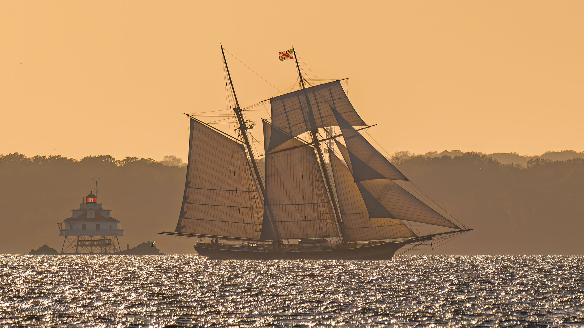 Pride of Baltimore II sailing past Thomas Point lighthouse