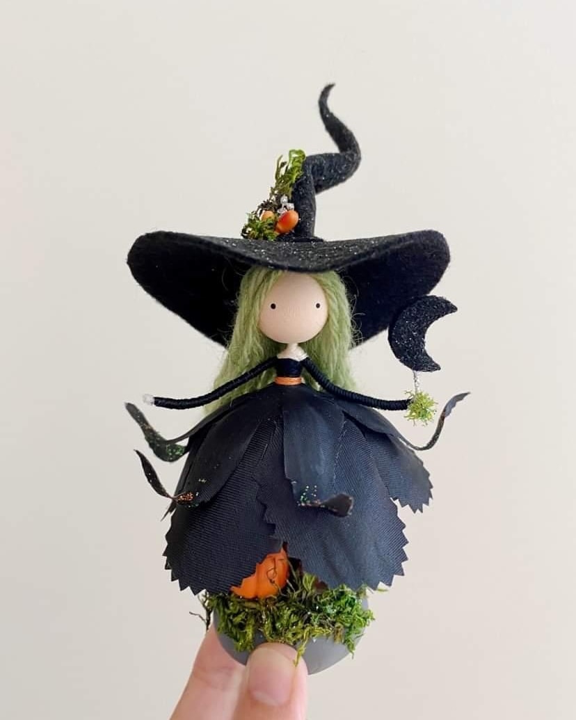 Handcrafted witch doll is made of felt and fabric. The doll has a