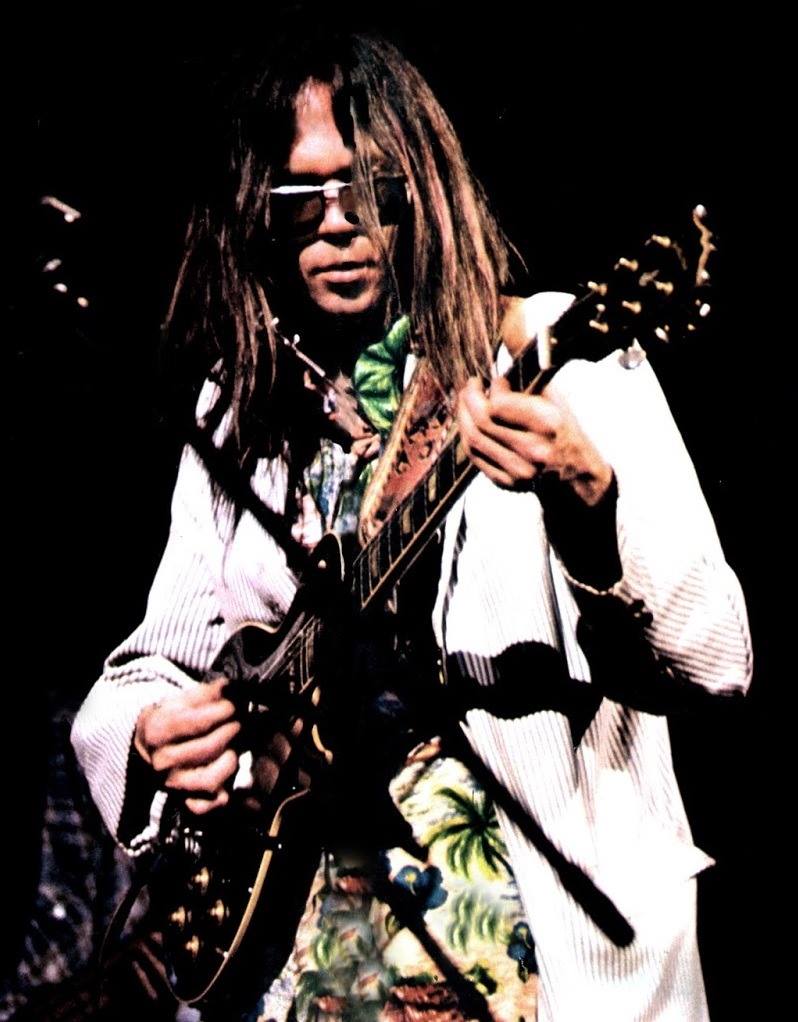 Neil Young performs with his band The Stray Gators at the Forum on