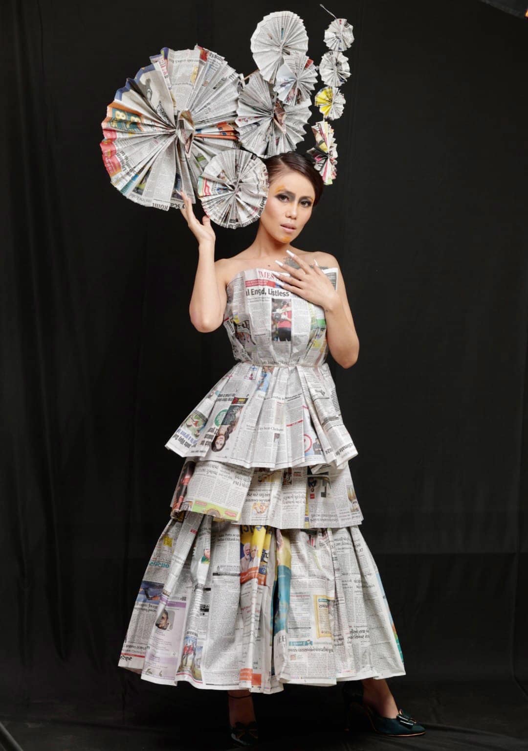 This avant-garde paper dress is not just a garment but a wearable piece of art, a celebration of nature's beauty, and a testament to the creative process and execution. The overall effect