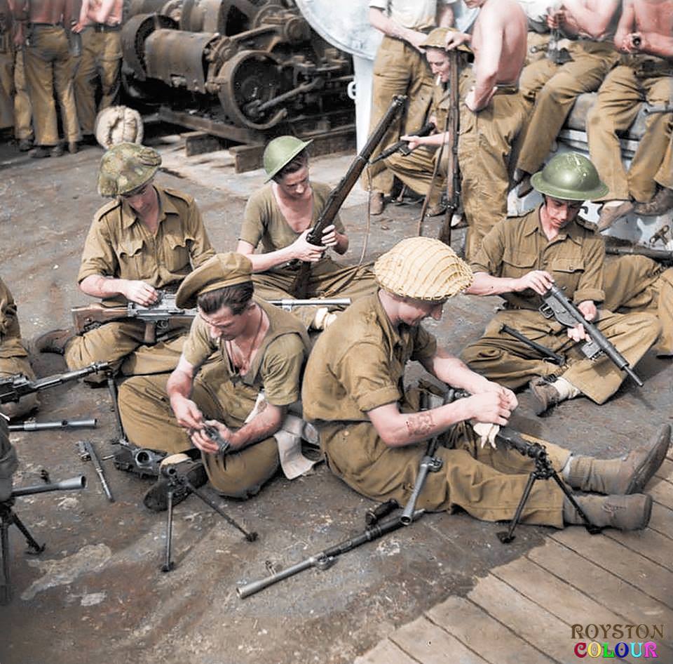 WW2 - Troops cleaning their weapons onboard ship, as part of the ...