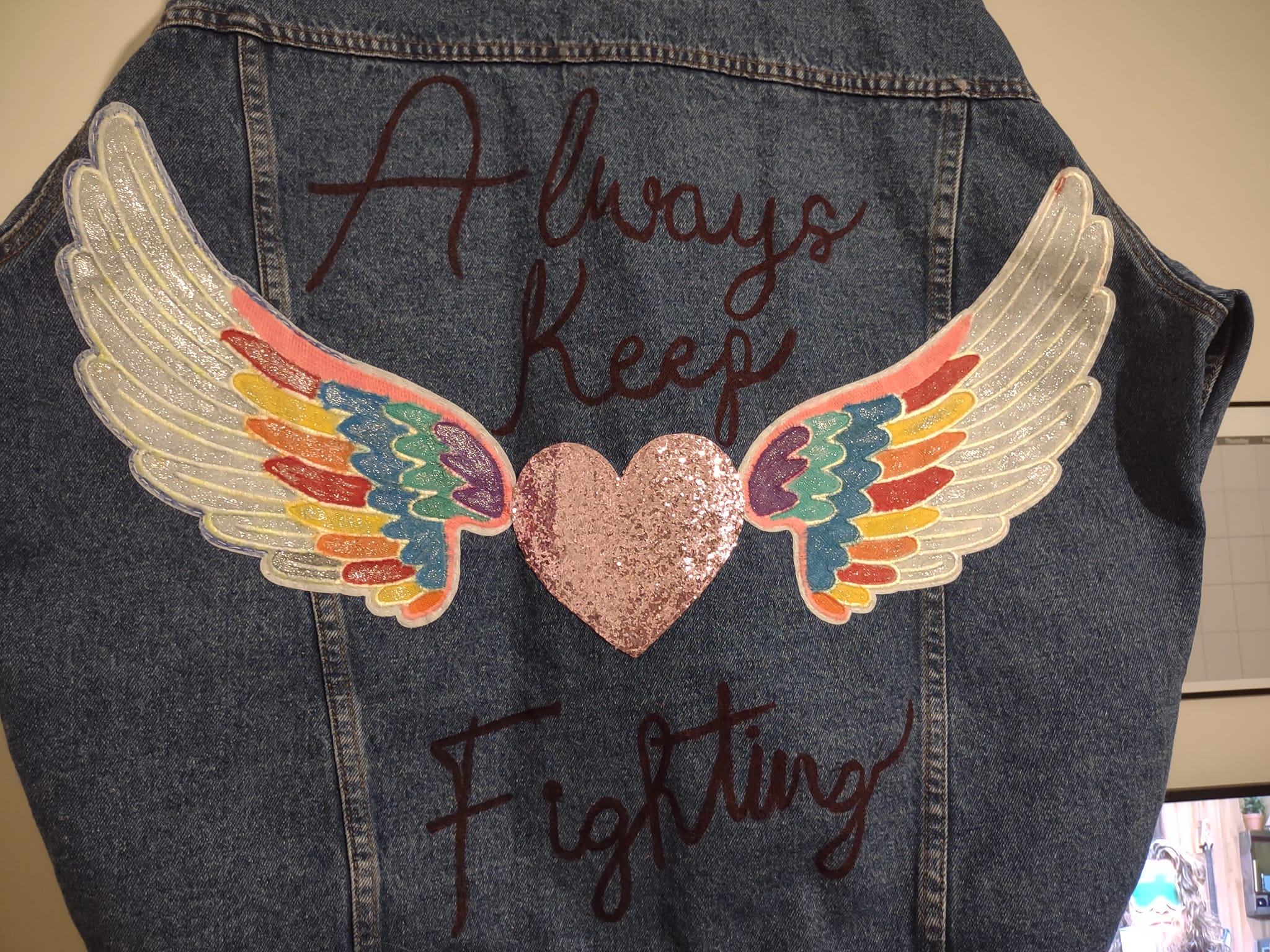 Upcycled denim jacket with embroidered letters and patches