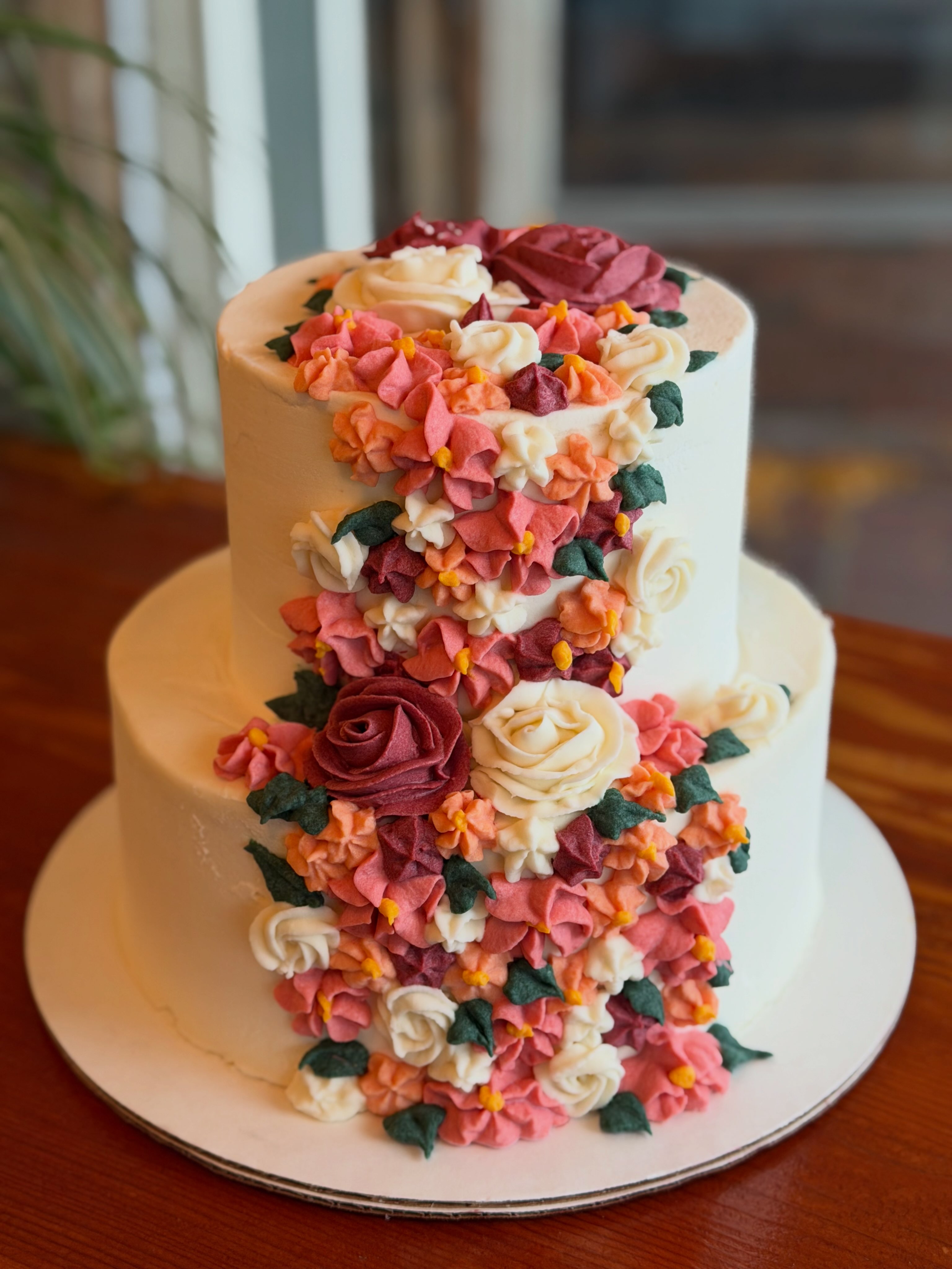 Two-tier vegan wedding cake with buttercream flowers