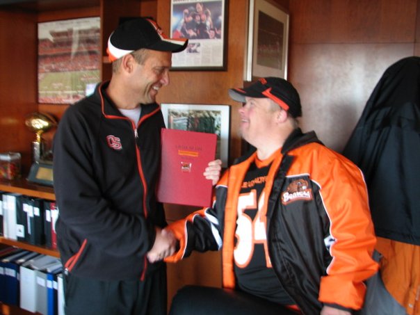 Timberhill - Tim presenting coach Riley with his book. | Facebook