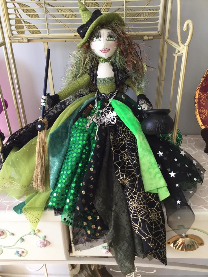 Handcrafted witch doll is made of felt and fabric. The doll has a