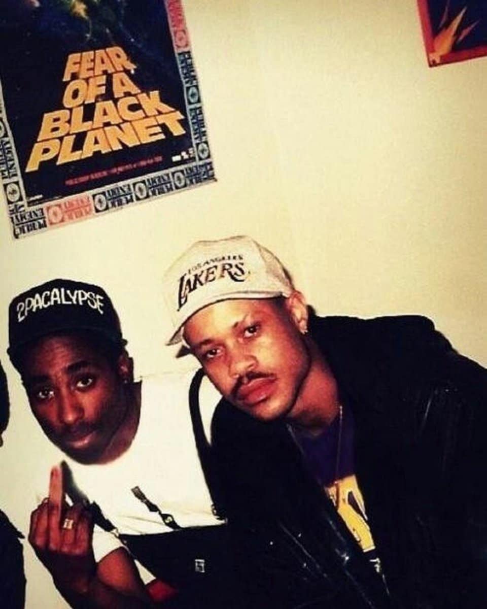 Two legends with the iconic poster behind them 🏆 2PAC & Guru 🤴🏾🤴🏾