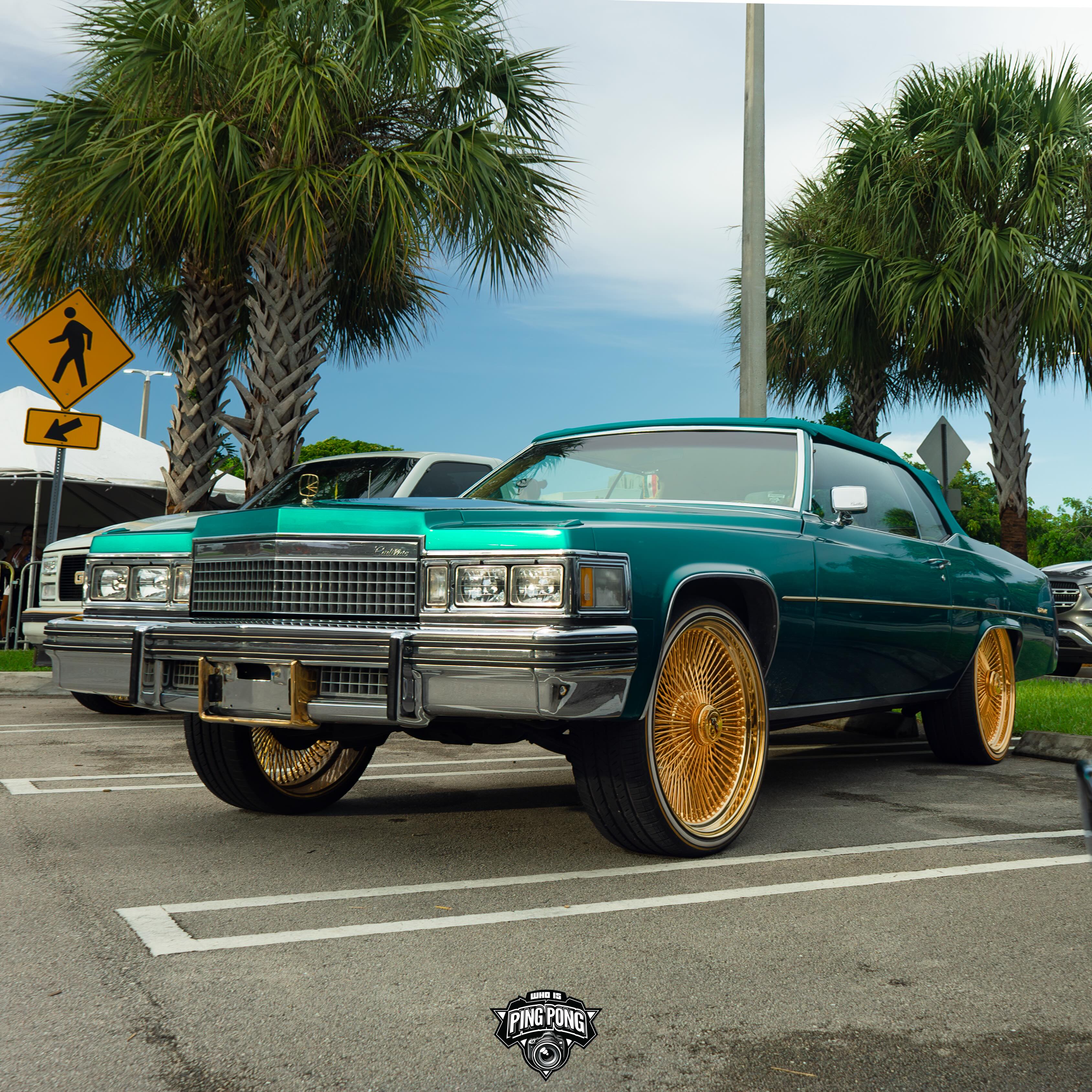 Teal Cadillac Le Cabriolet on gold Dayton wire wheels in Miami Gardens