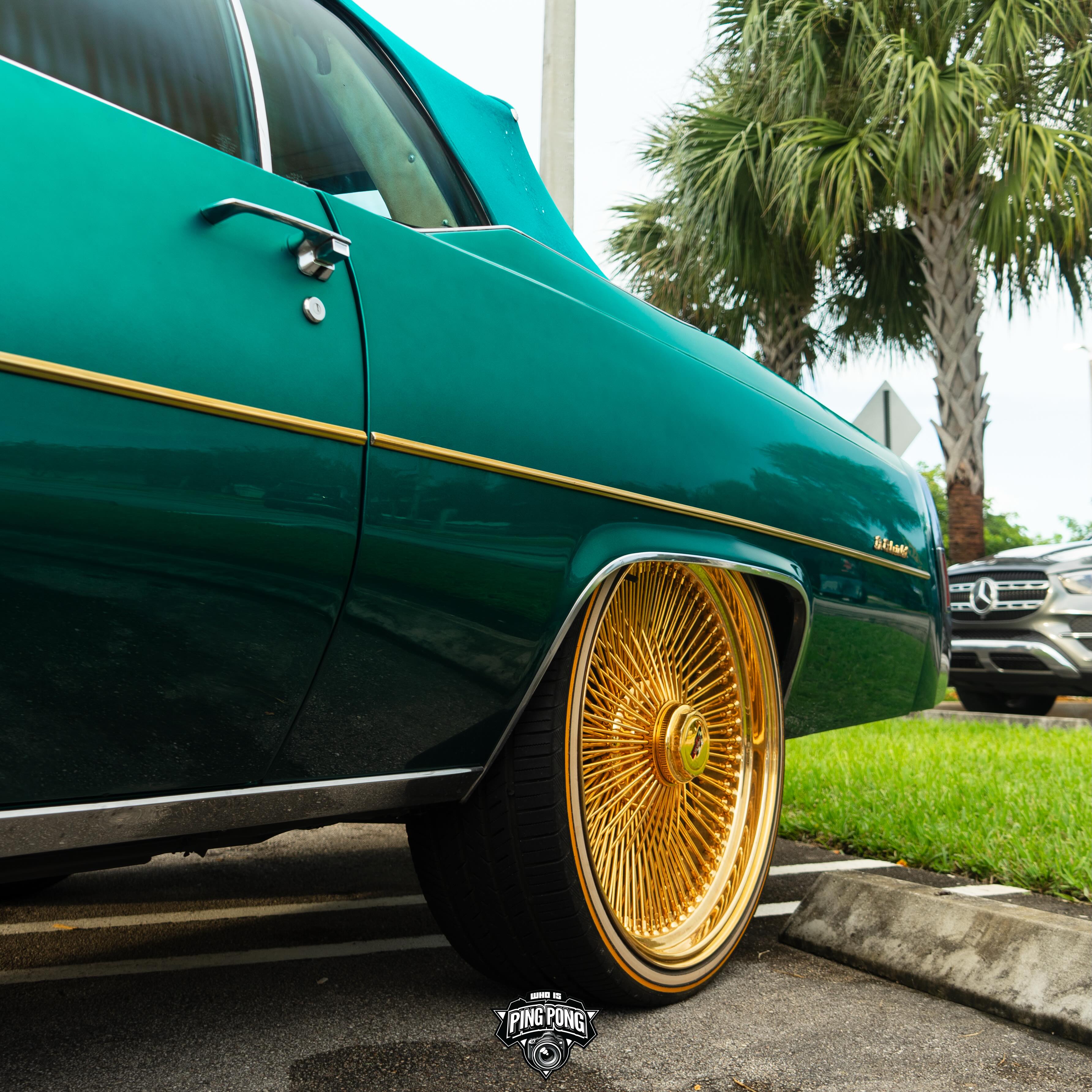 Teal Cadillac Le Cabriolet on gold Dayton wire wheels in Miami Gardens