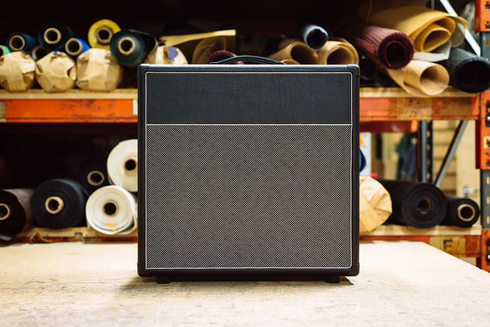Modern 2x12 in red bronco tolex with black grill and white piping