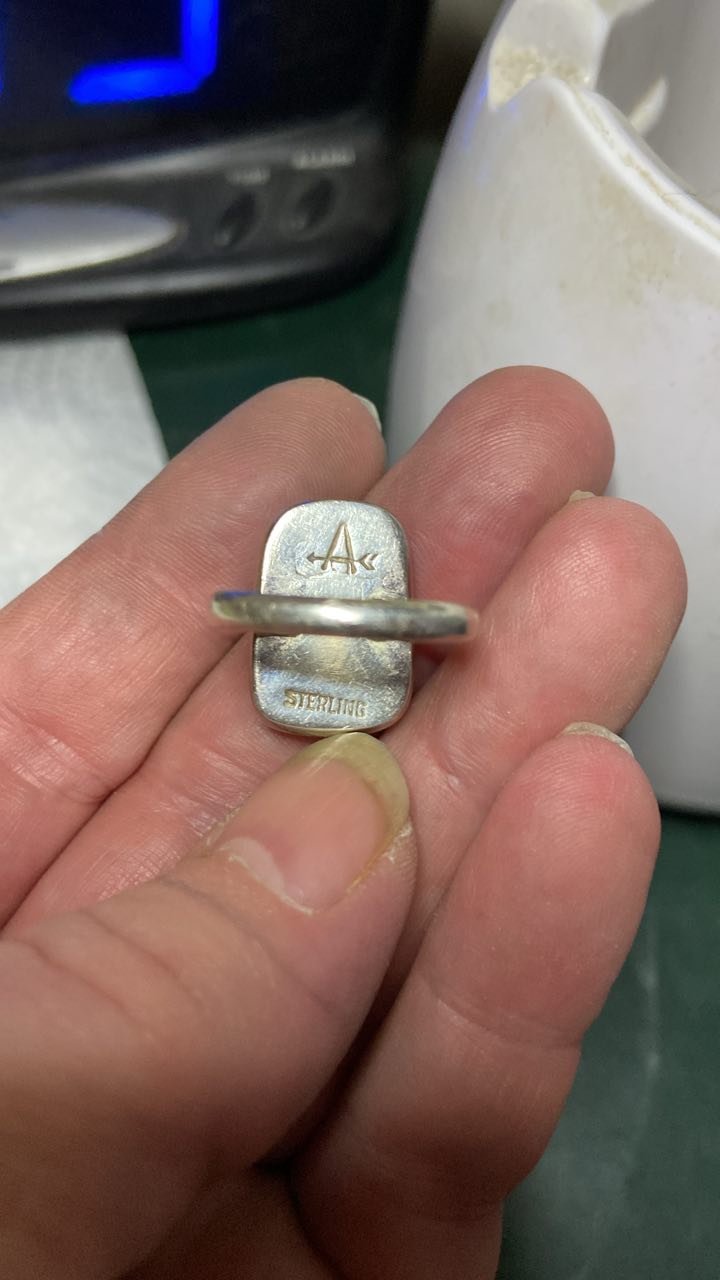 What is the meaning of a cursive 'A' stamp on Native American