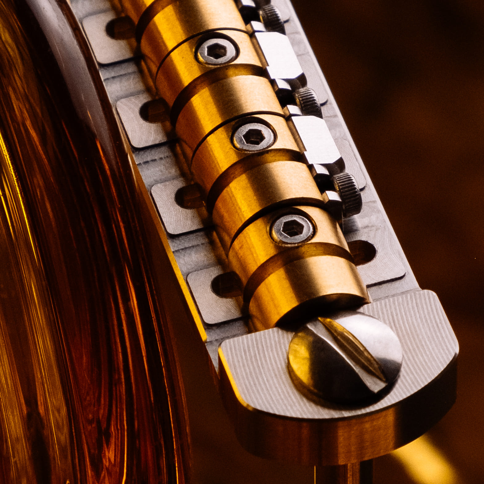 Tuffset bridge with raw brass saddles for offset guitars