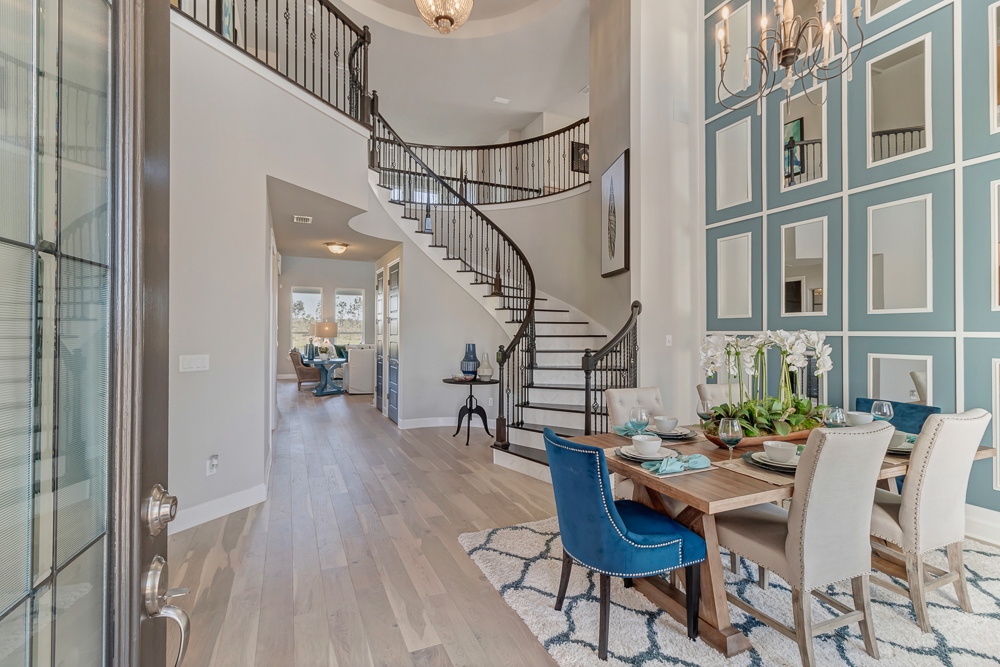 A curved staircase brings an... - Adele Designer Homes