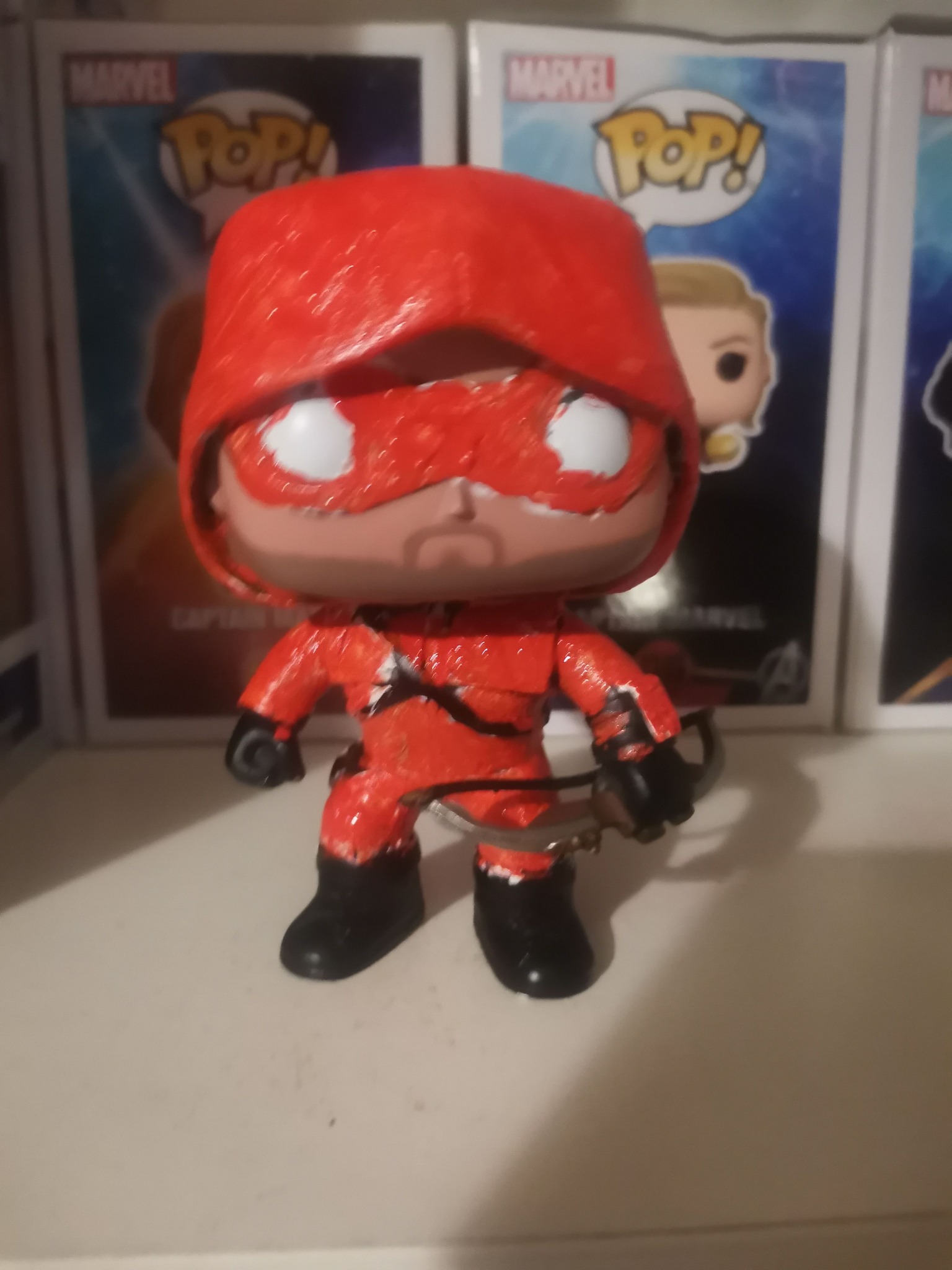 What Funko Pop has a red hoodie, blue jeans, and brown hair?