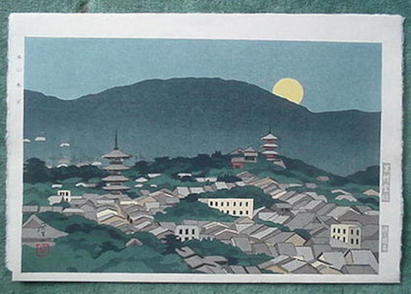 A Town as the Moon is Rising Over the Mountains