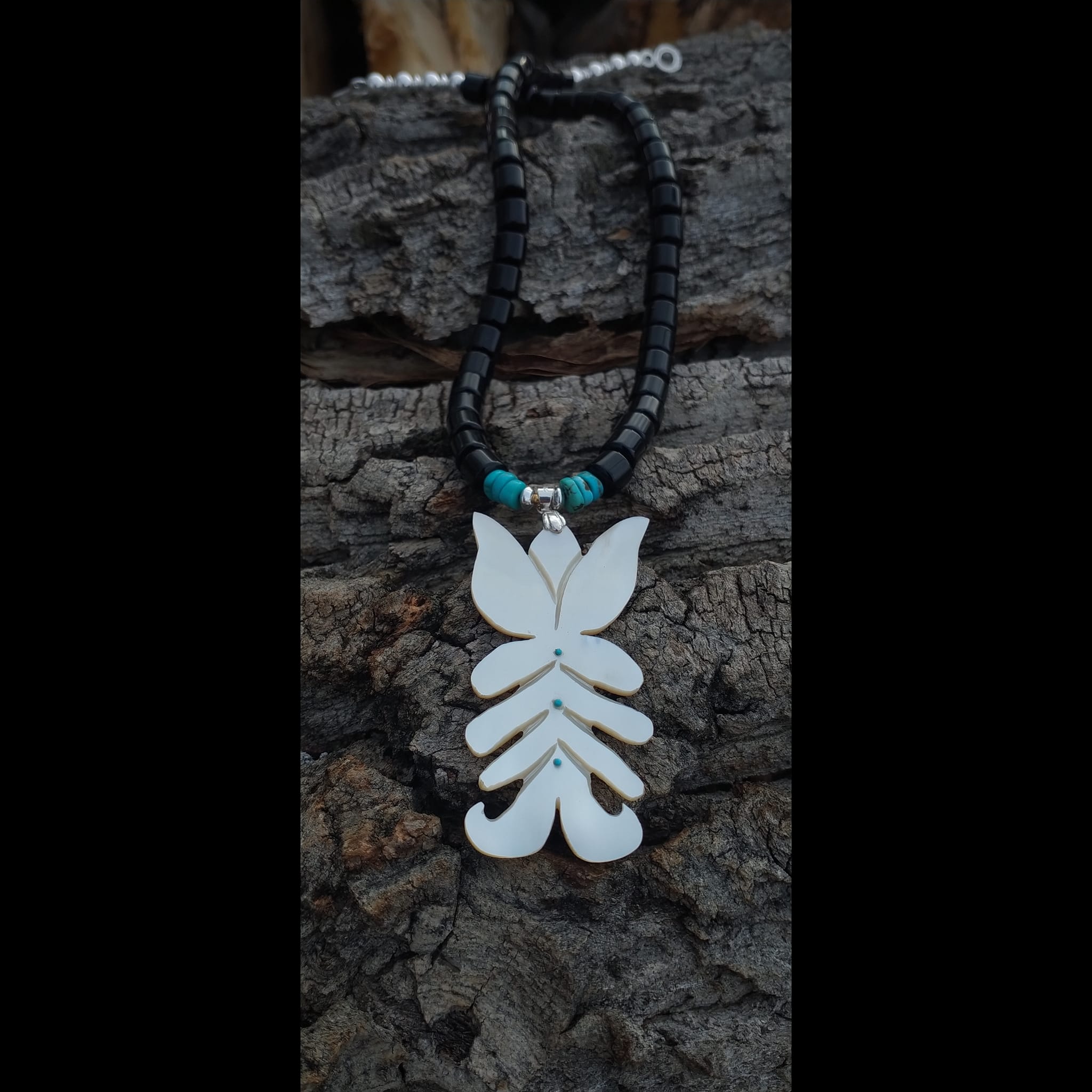 What is the signature on this black onyx silver necklace?
