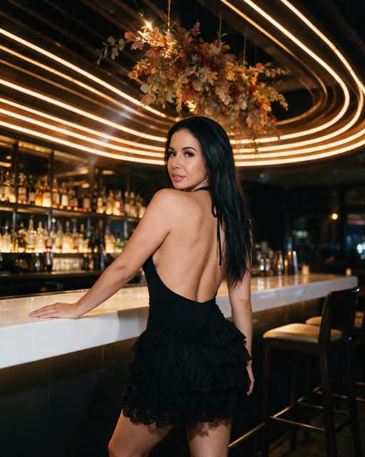 Backless black lace tiered mini dress, glowing lounge bar, and modern halo lighting: what should we order first, espresso martini or vintage champagne? 🍸✨ #latina #viral #loungevibes #nightlife #glam