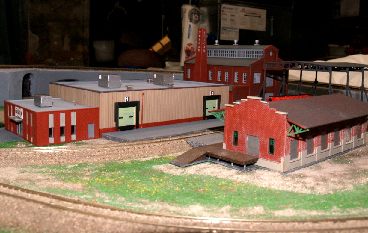 N scale model train layout with city and rural scenery