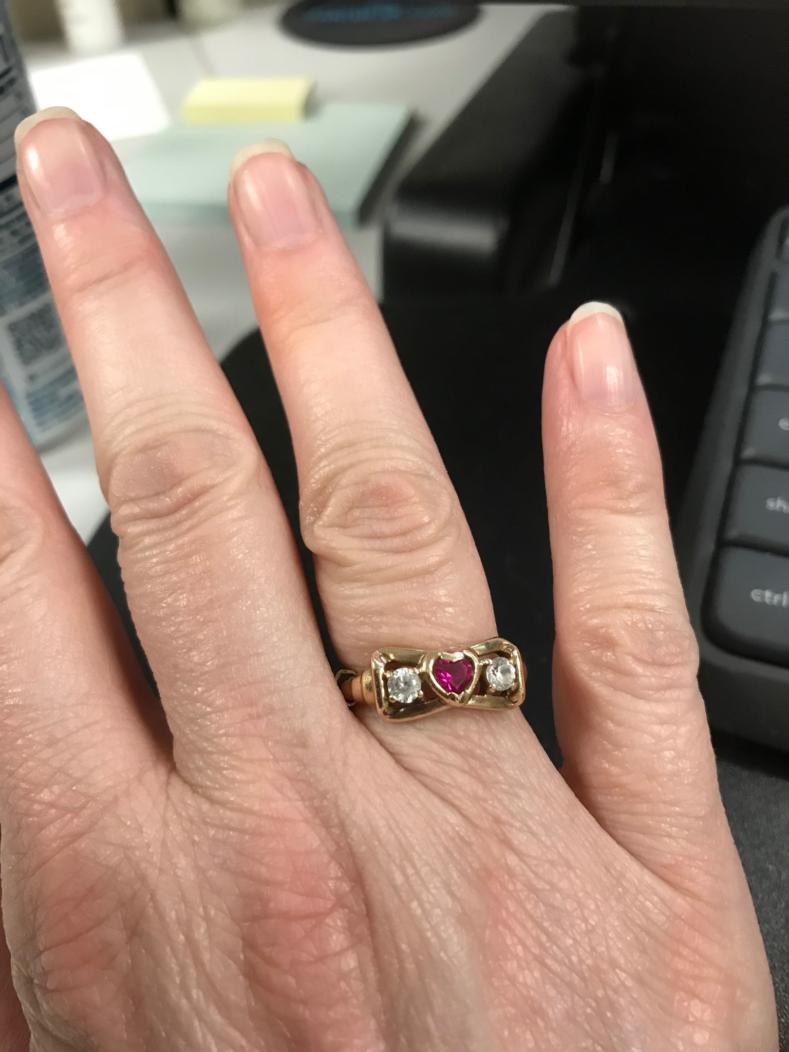 What is the origin and value of a vintage ring with intertwined 