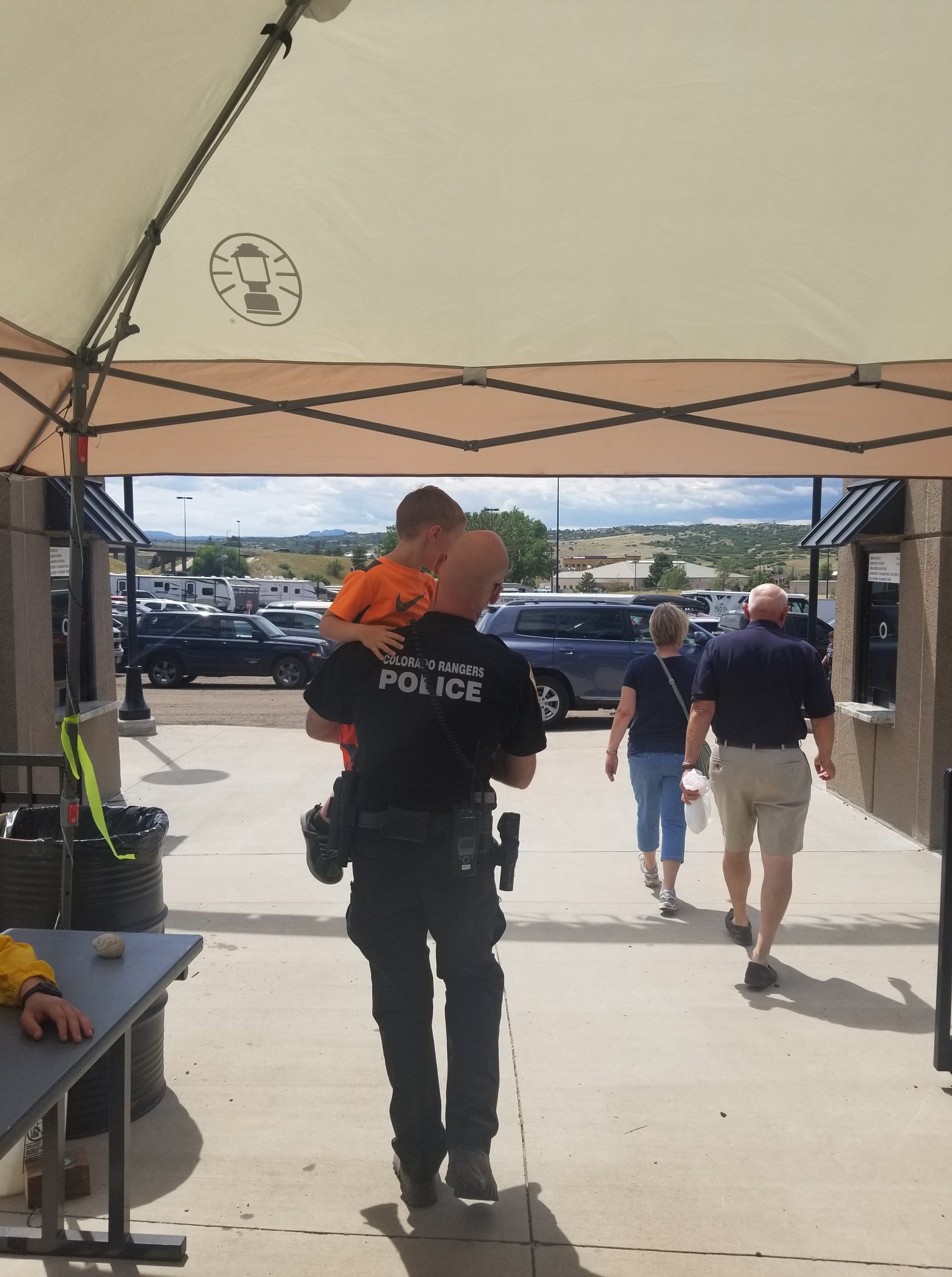 A ranger carrying a dehydrated child to... - Colorado Rangers