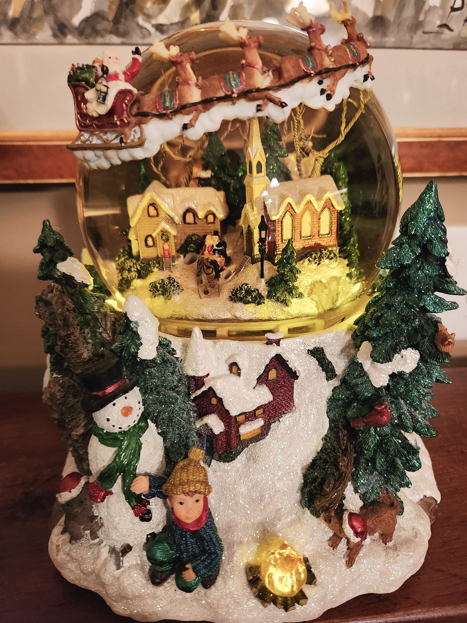 Festive Kirkland Signature snow globe has a glass dome with a