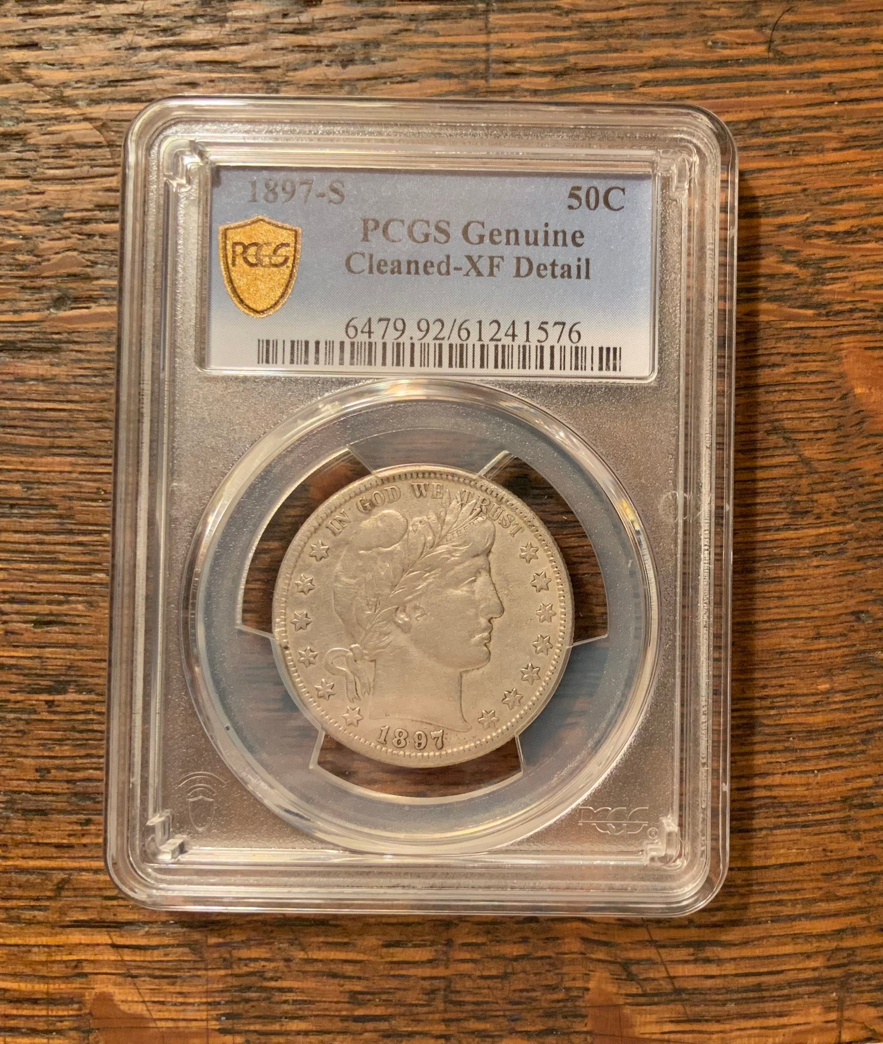 Why is my 1897s barber half dollar graded as cleaned?