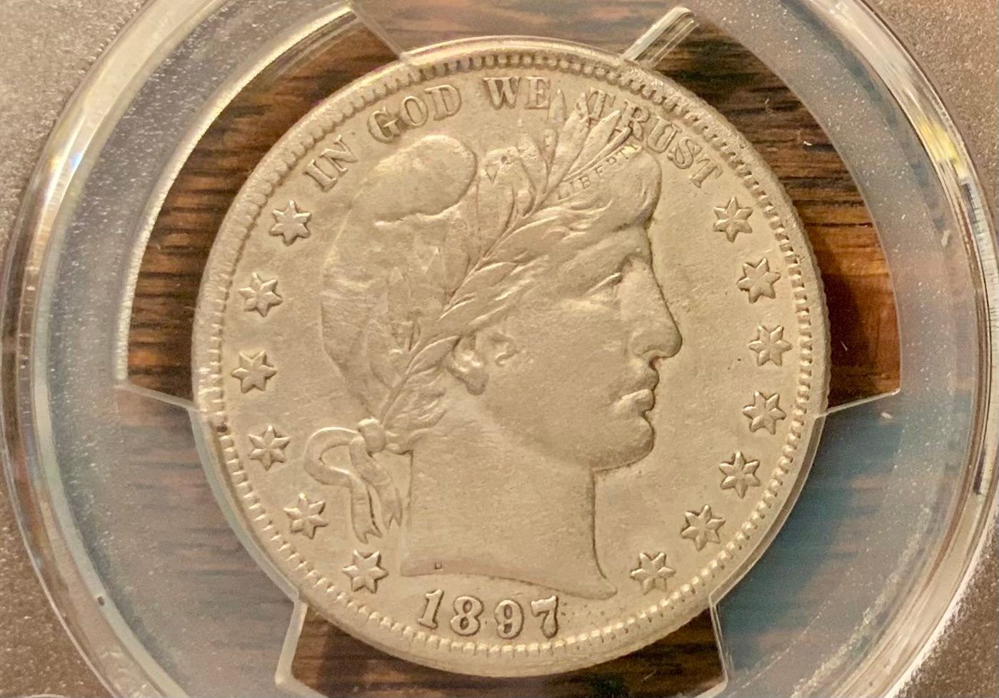 Why is my 1897s barber half dollar graded as cleaned?
