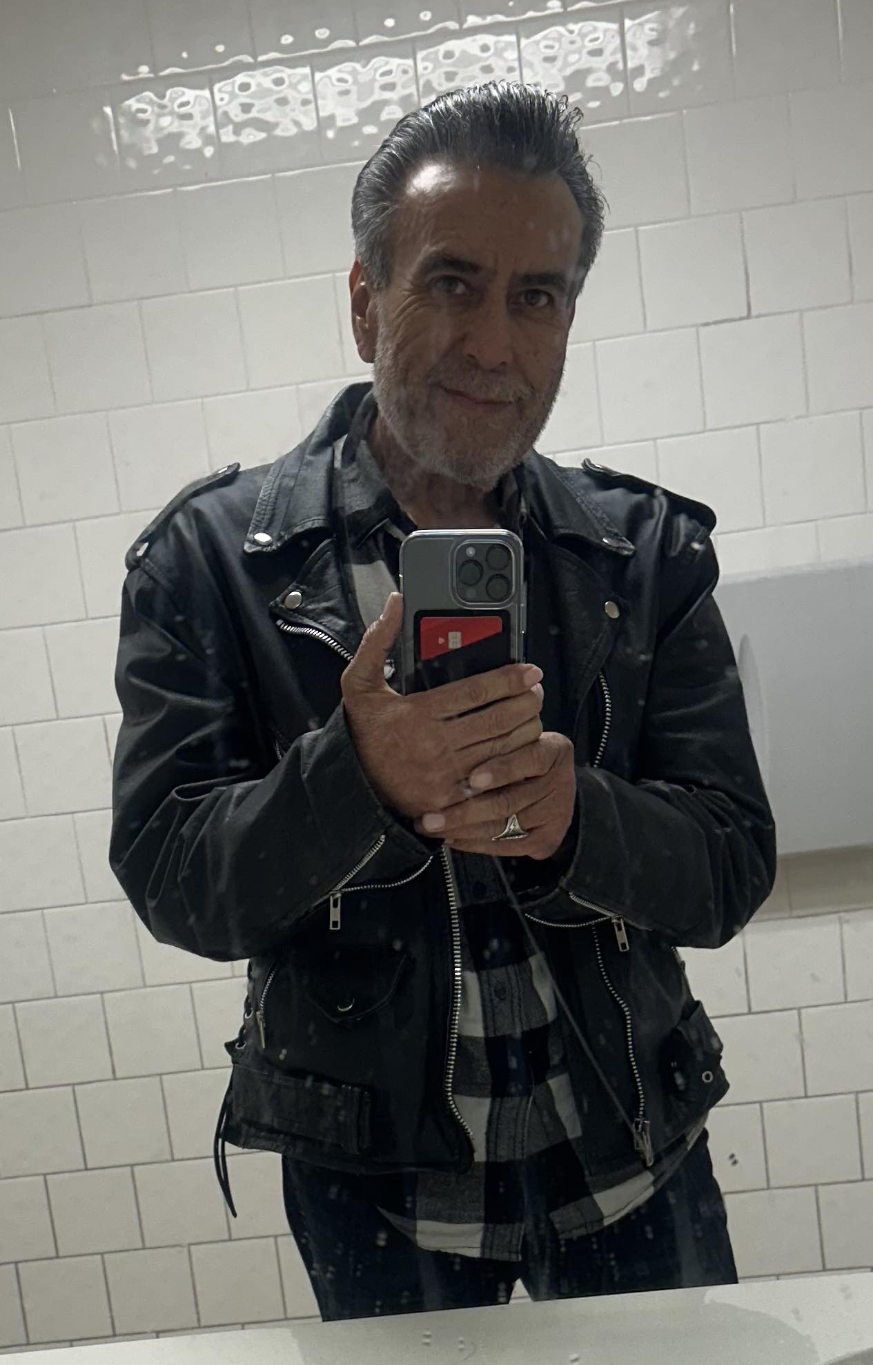 Man fits in old leather jacket at 63
