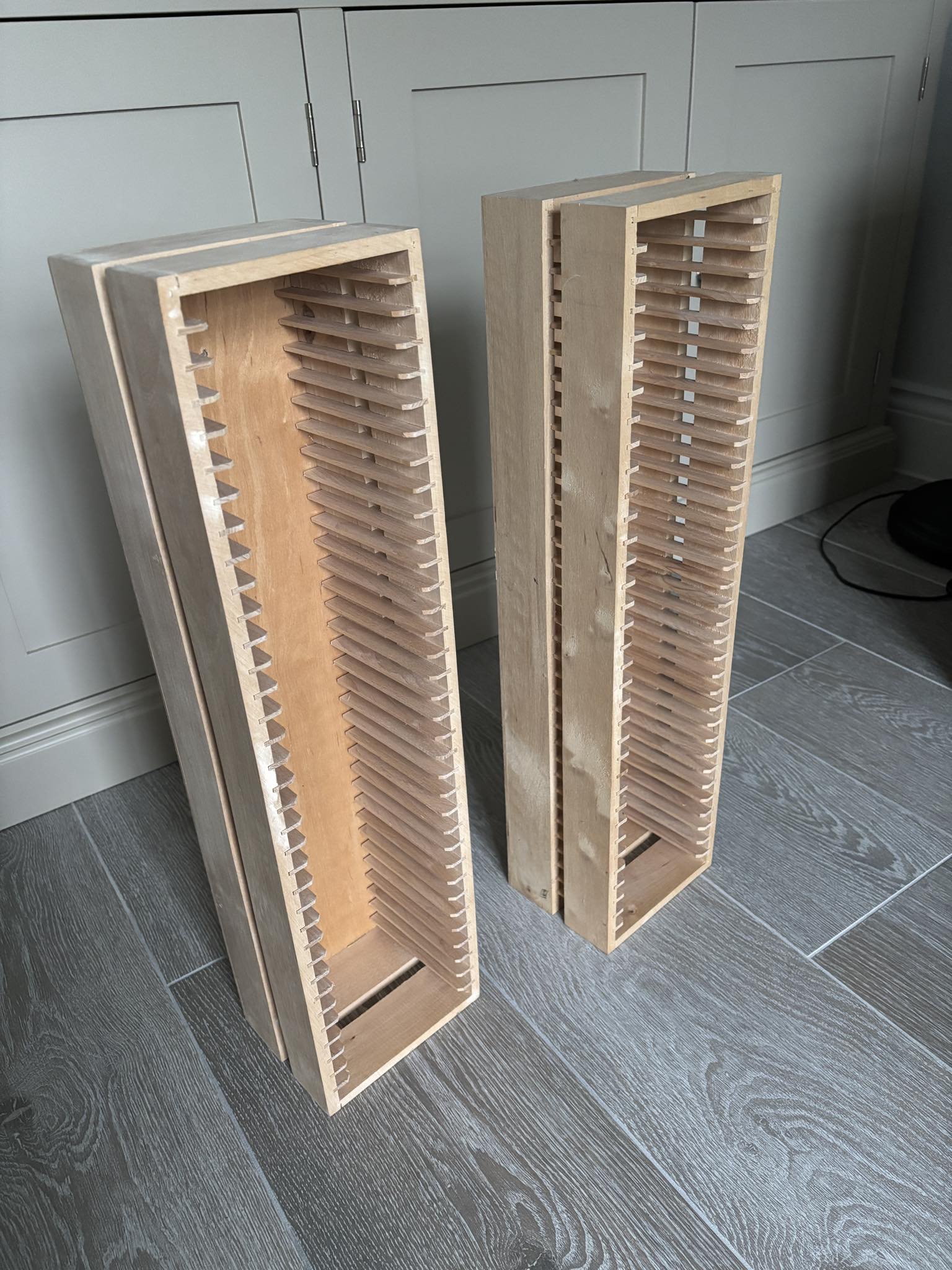 Pair of wooden CD holders (IKEA) each one holds 35 CDs and stands 58cm high. Free to collect