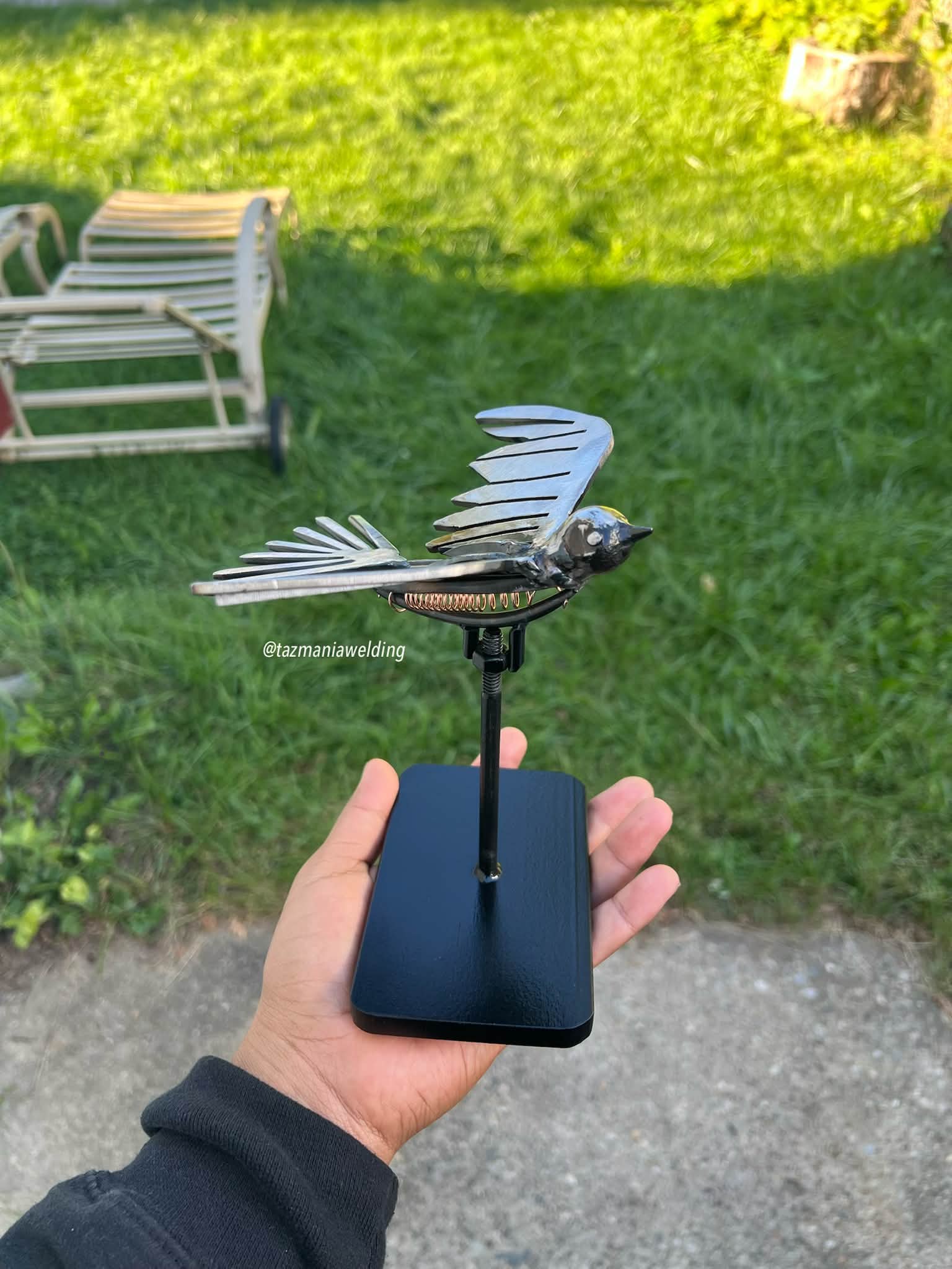Metal bird sculpture with moving wings for indoor or outdoor display
