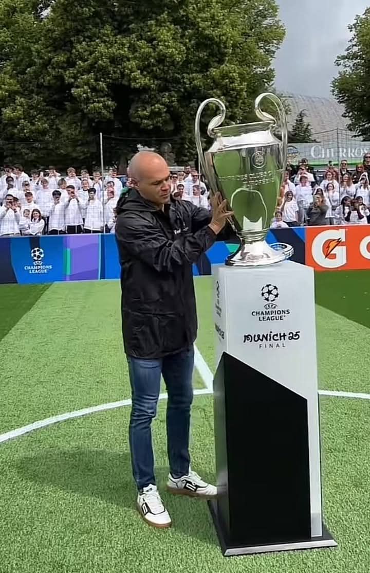 Andrés Iniesta has delivered the UEFA Champions League trophy to
