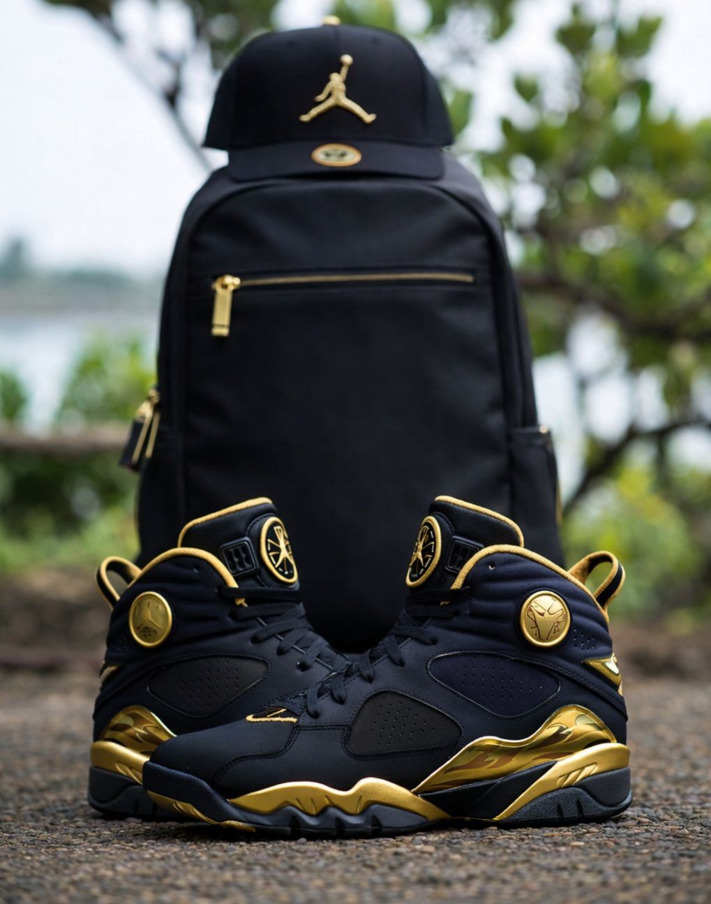 Black and gold Jordans paired with backpack equals pure luxury
