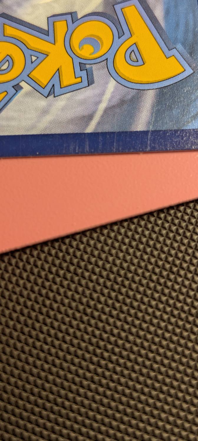 Is a Pokémon card with light scratches still near mint?