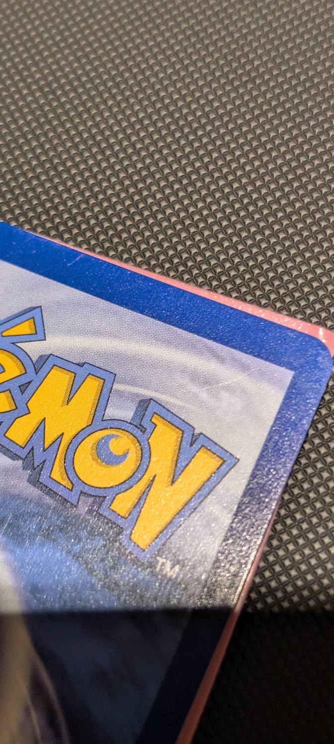Is a Pokémon card with light scratches still near mint?