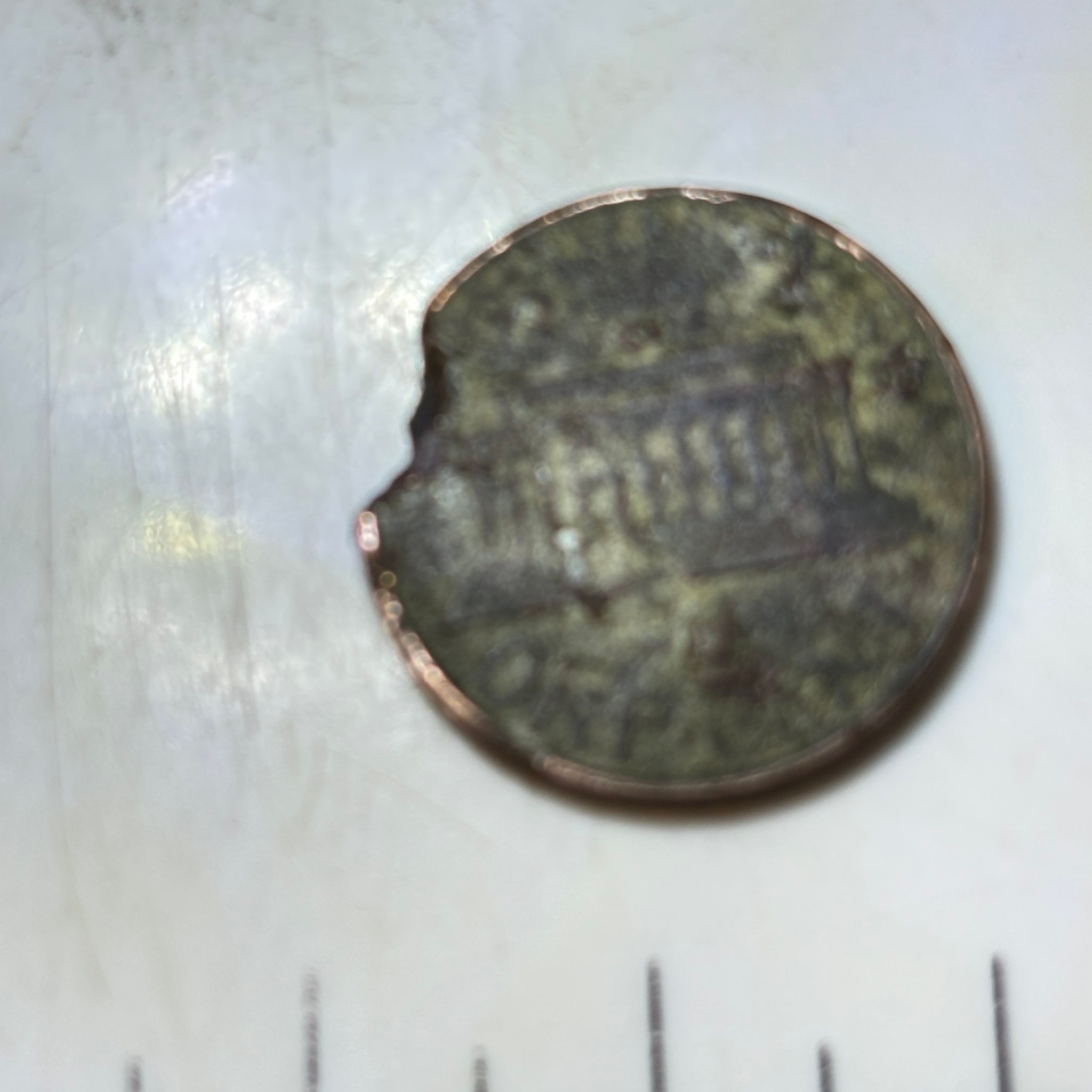 What is this coin with hole spots?