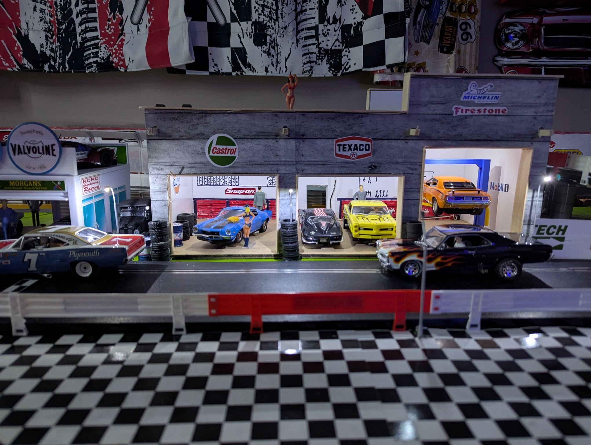 Foam board model garage with Michelin, Texaco, and Castrol details