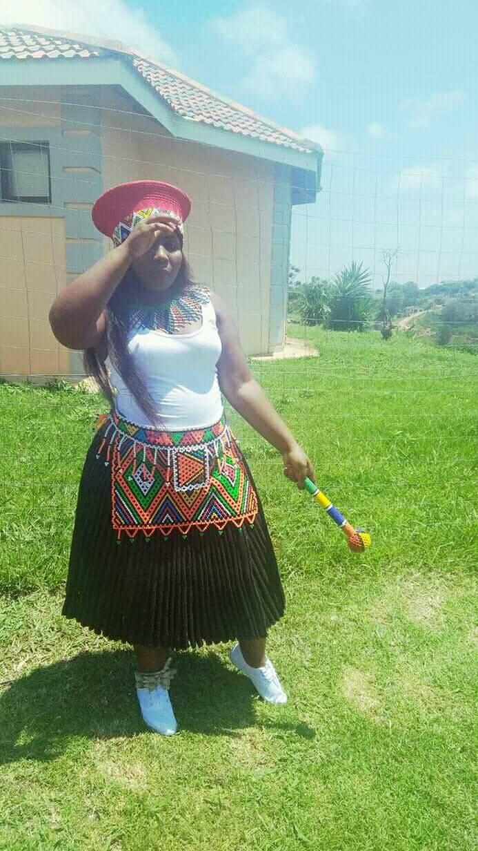 Traditional Zulu outfit with isidwaba skirt and inkehli hat