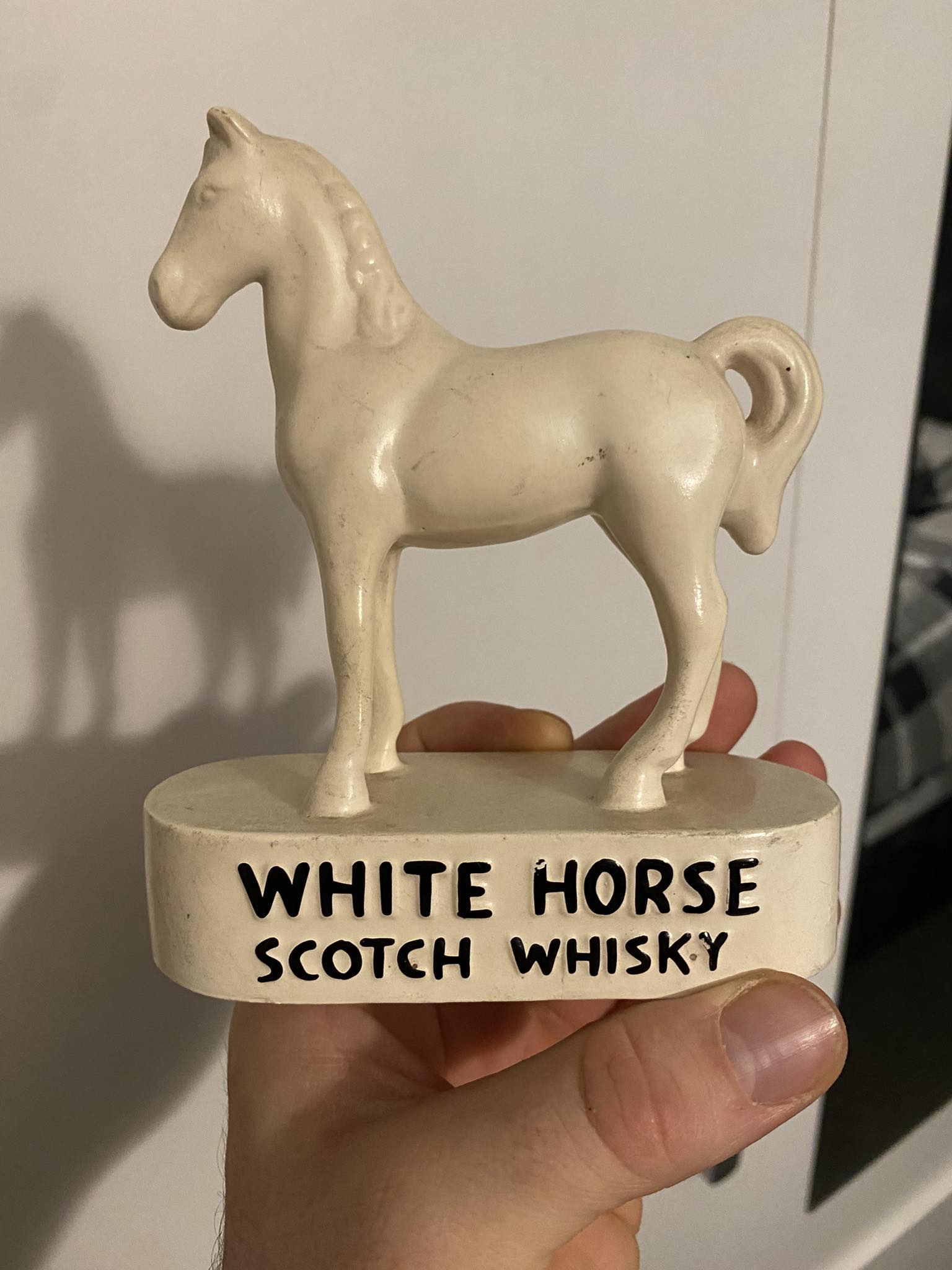 A rare early original collectible figure branded 'White Horse