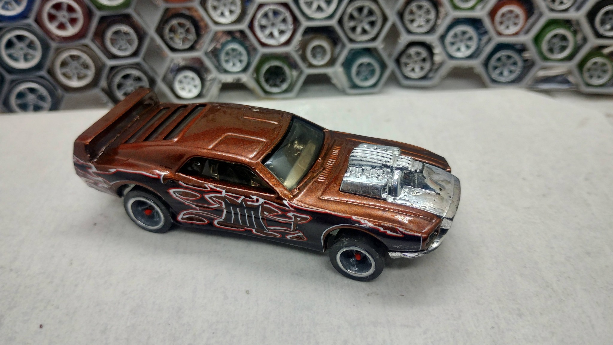 Custom die-cast car with candy orange paint and CM5 wheels