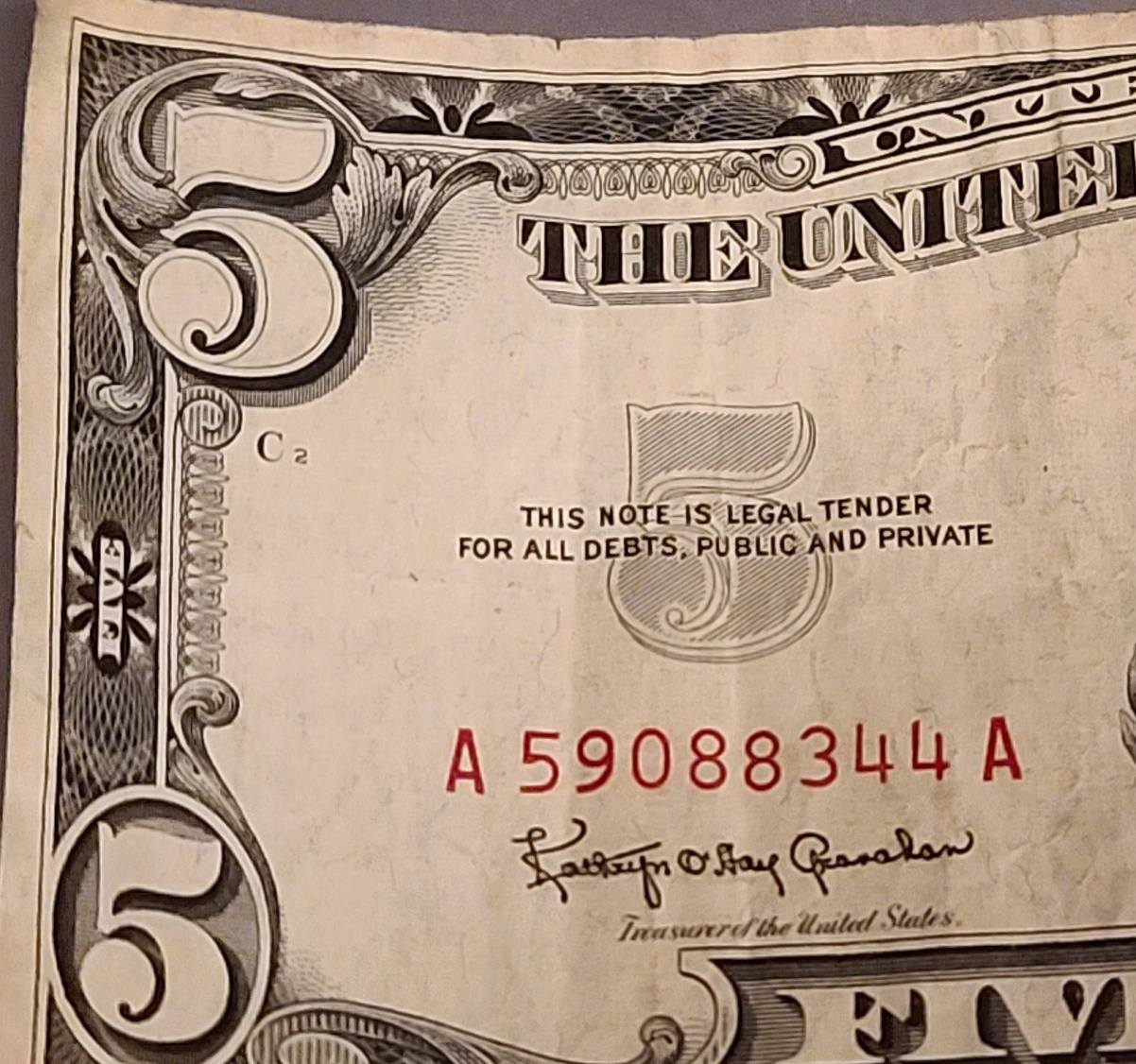 Is a red dye stained $5 bill common?