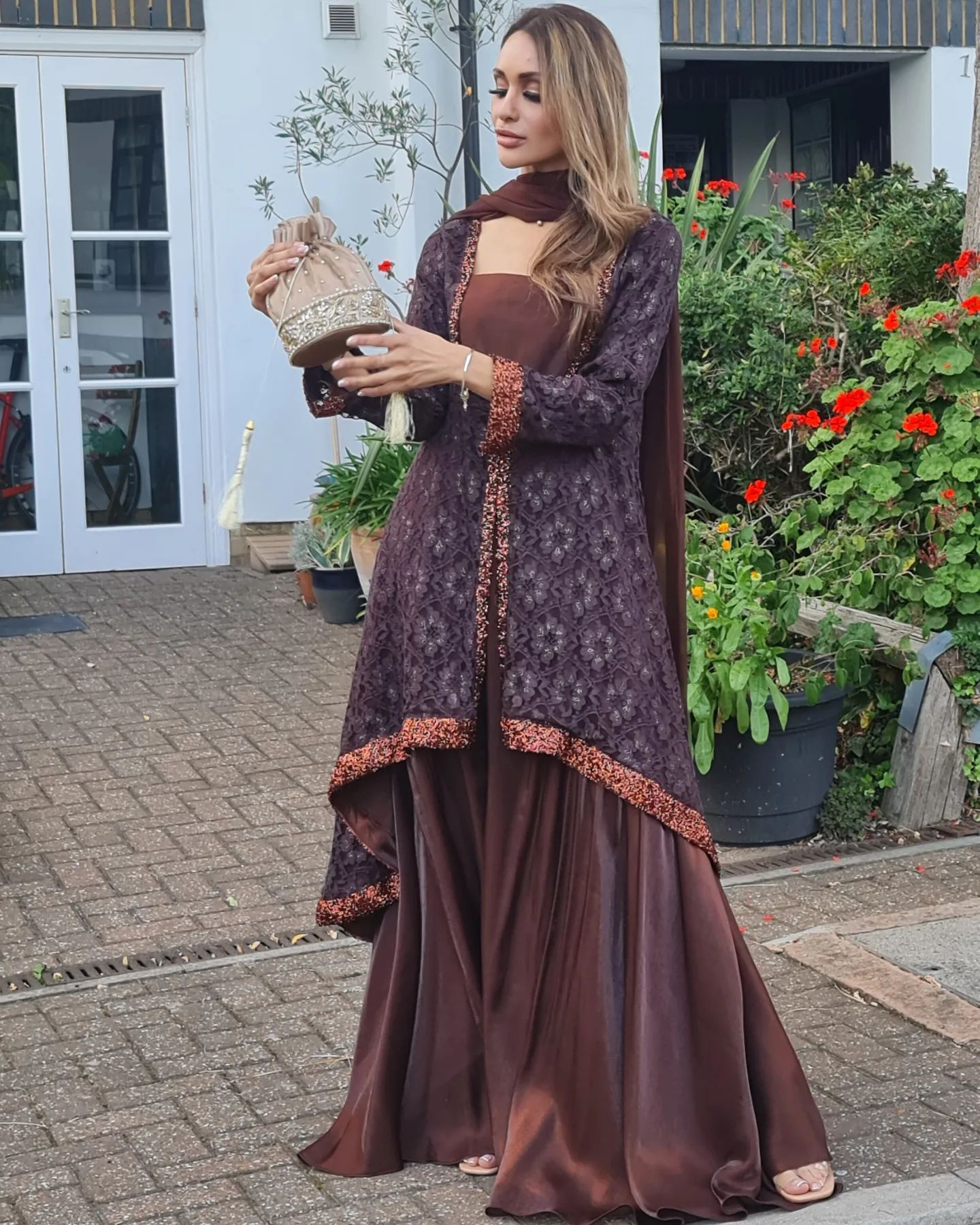 A beautiful chantilly net double neck front open style back drop frock with lace work.it is paired with shimmery loose fit flary palazoo and lace work chiffon dupatta