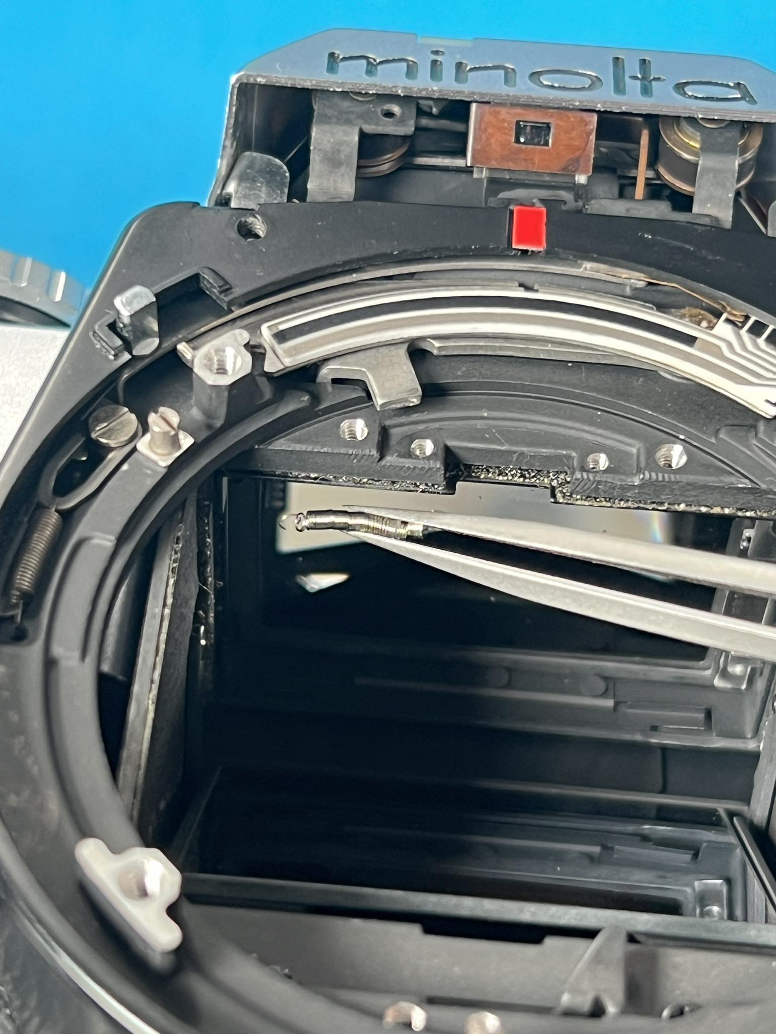 Reattaching viewfinder display scale spring on Minolta XD7?