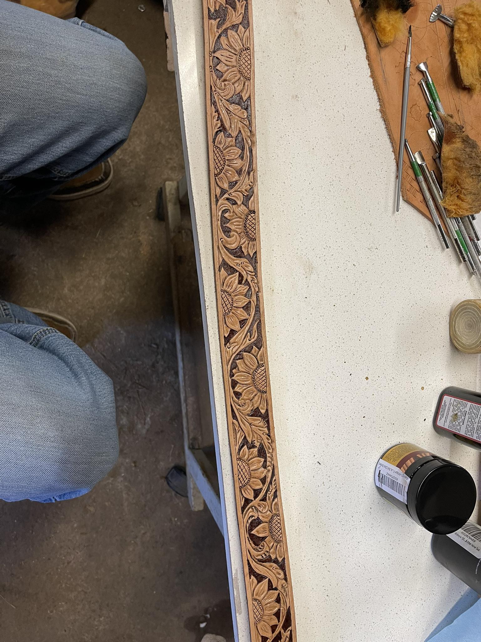 Can I stain leather belt border after tan coat?