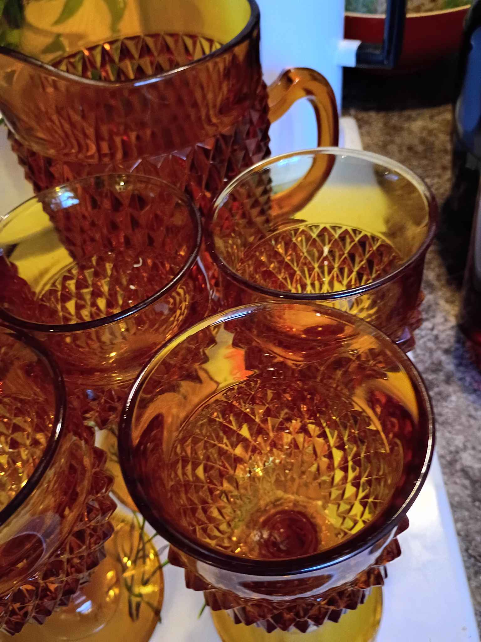 Beautiful amber glass pitcher and matching glasses set. Has a cool