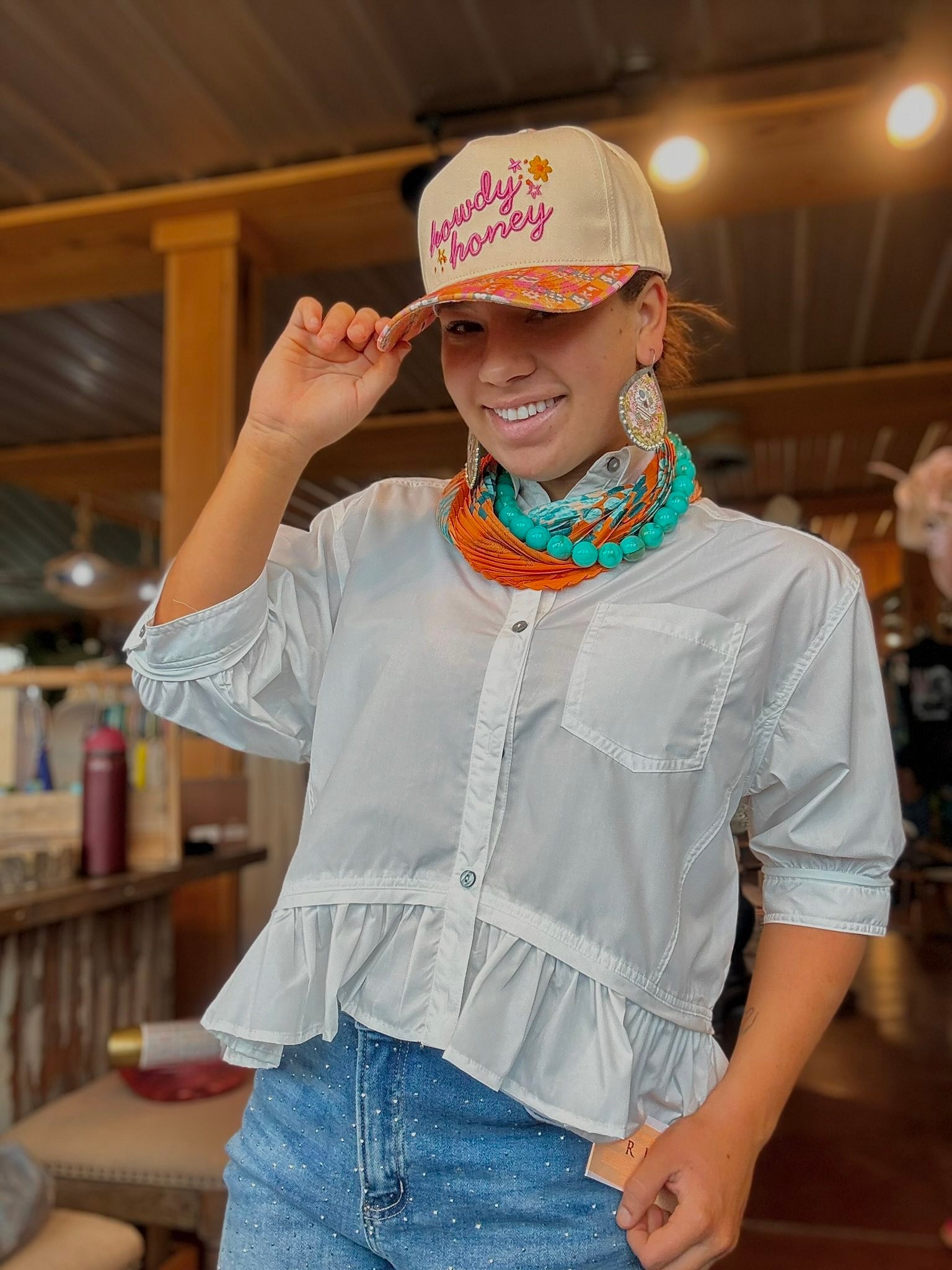 Off-White Ruffle Top with vibrant accessories