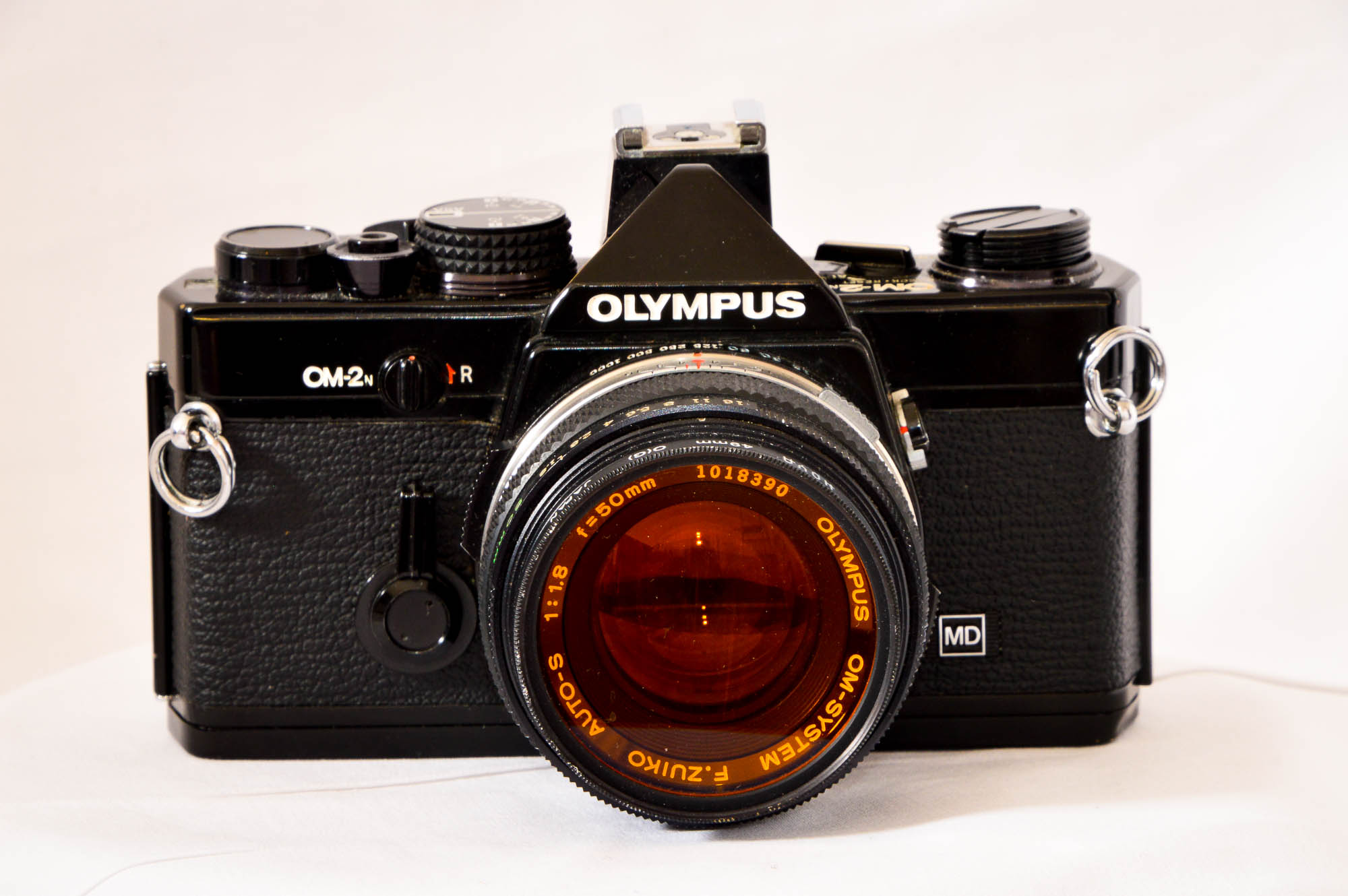 Olympus OM2n camera collection with 28mm, 35mm, 50mm, and 135mm lenses