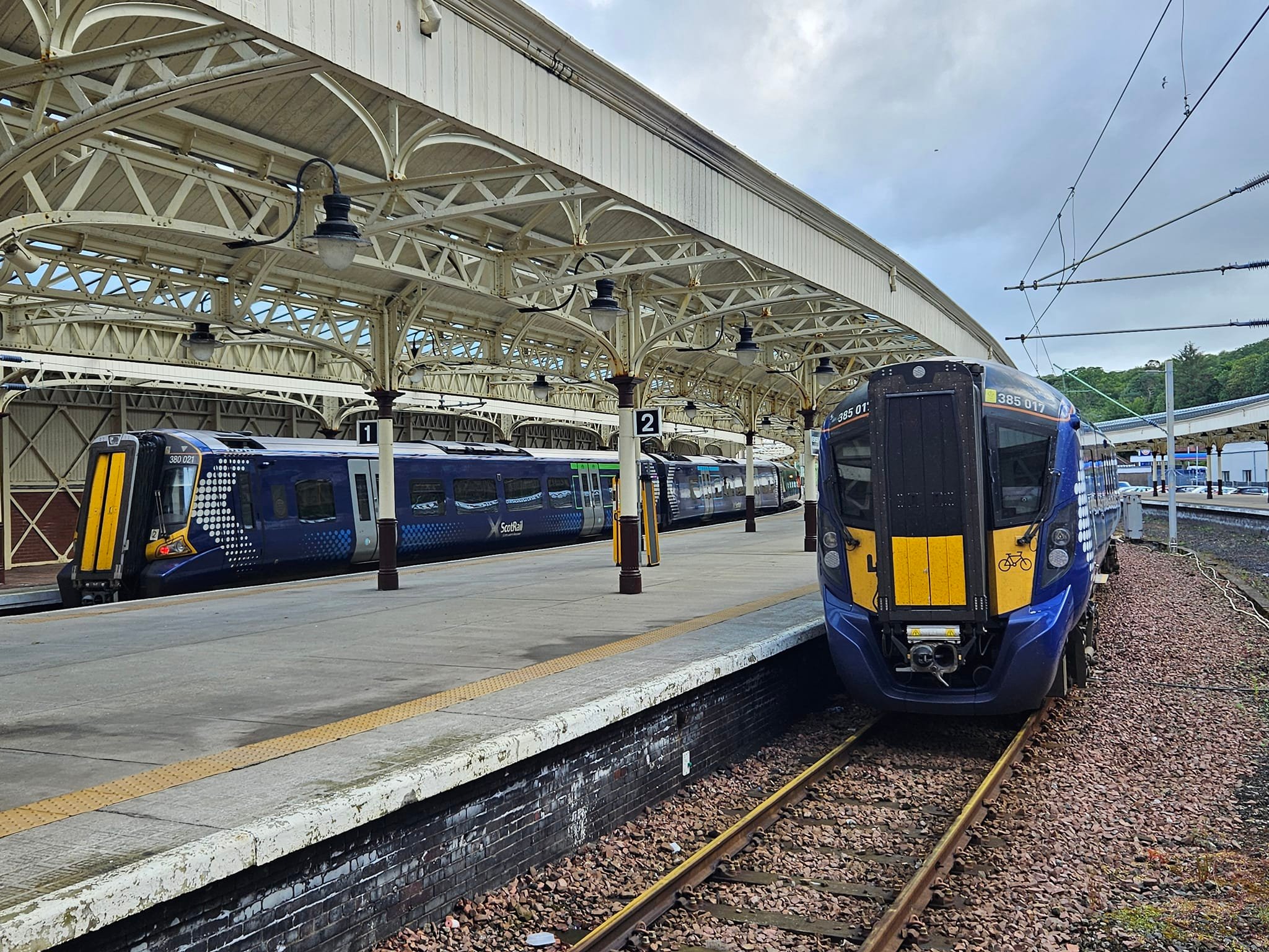 Double class 158 train passes through trees near Edinburgh Waverley
