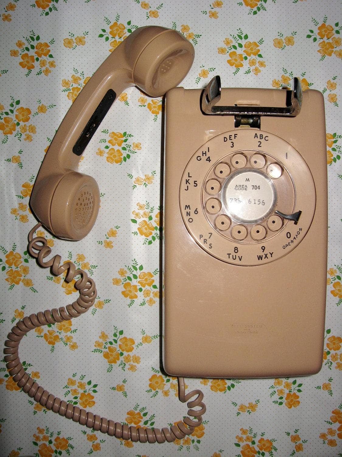 A rotary dial wall phone from the 1970s.